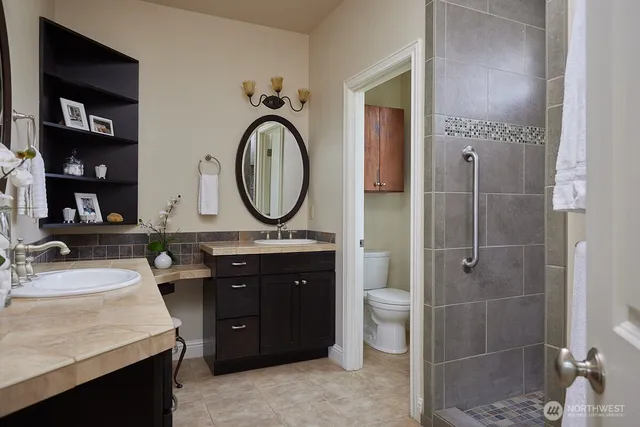 a bathroom with a sink vanity granite and a mirror