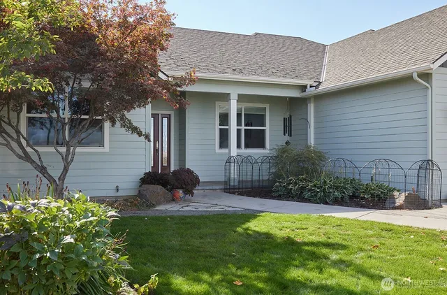a view of a house with a yard and plants