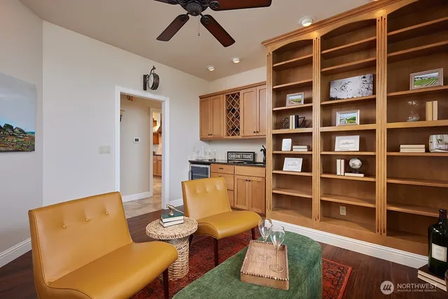 a living room with furniture and a book shelf