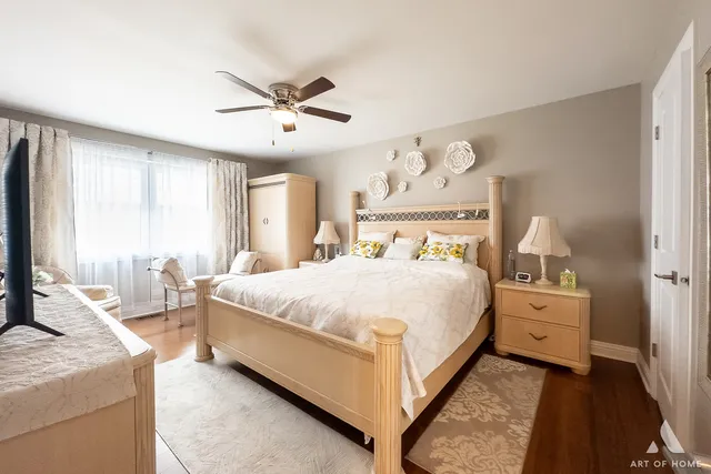 a bedroom with a bed and a flat tv screen on dresser