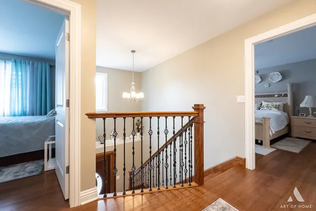 a kitchen with a sink and a stove with wooden floor