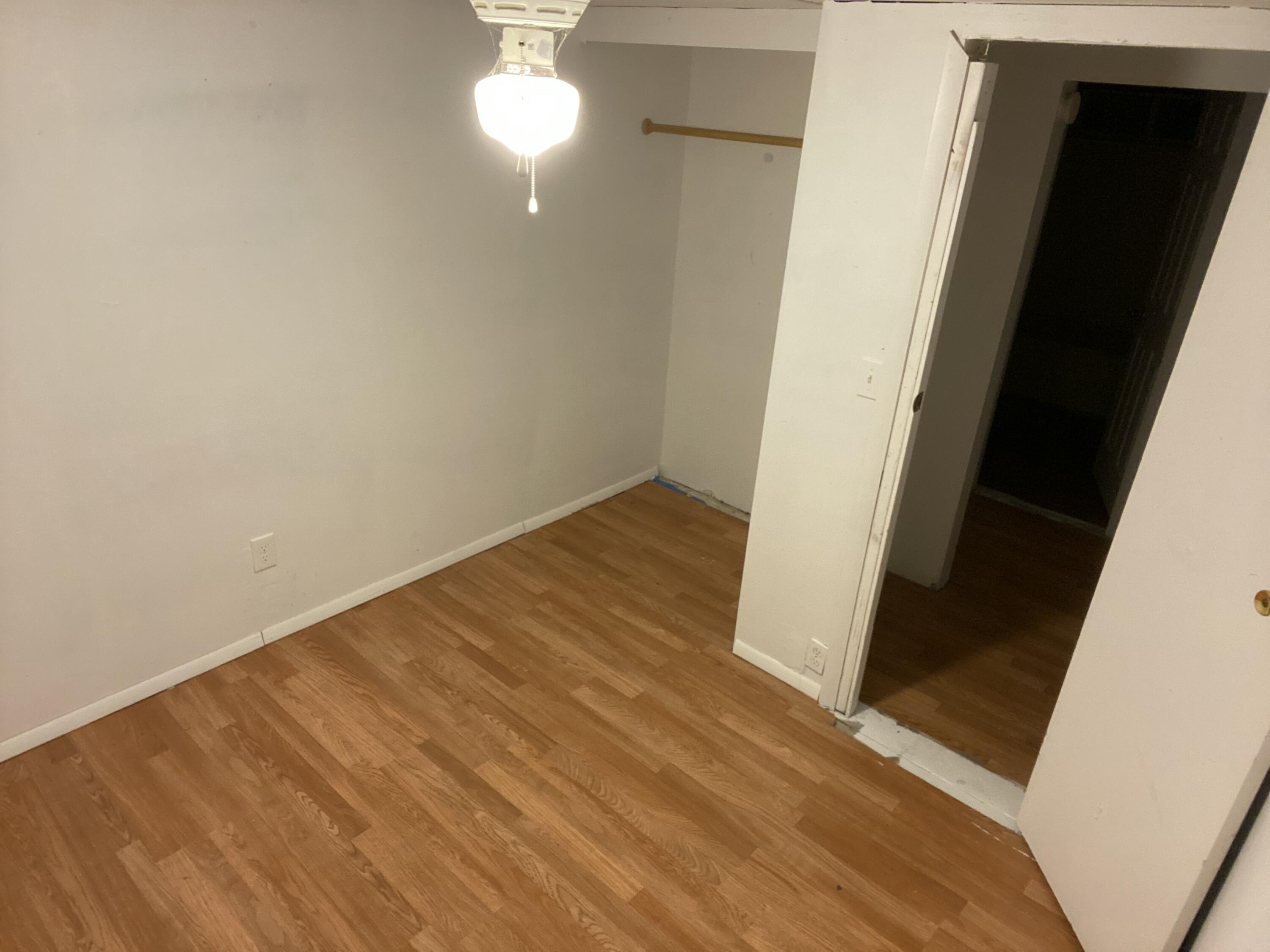 7835 Southeast 60th Drive Okeechobee, FL 34974 - Photo 18 of 35 en empty room with wooden floor and fan