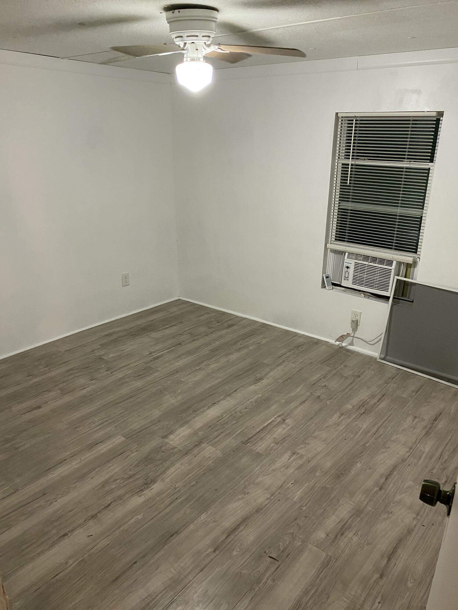 7835 Southeast 60th Drive Okeechobee, FL 34974 - Photo 20 of 35 a view of a room with wooden floor and window