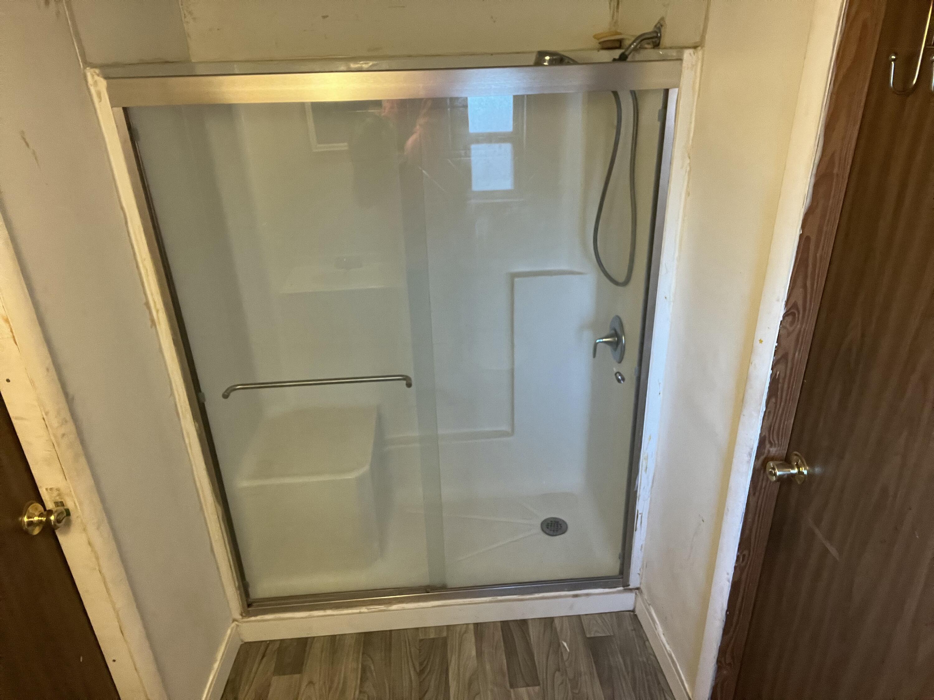 7835 Southeast 60th Drive Okeechobee, FL 34974 - Photo 22 of 35 a bathroom with a glass shower door and a sink window
