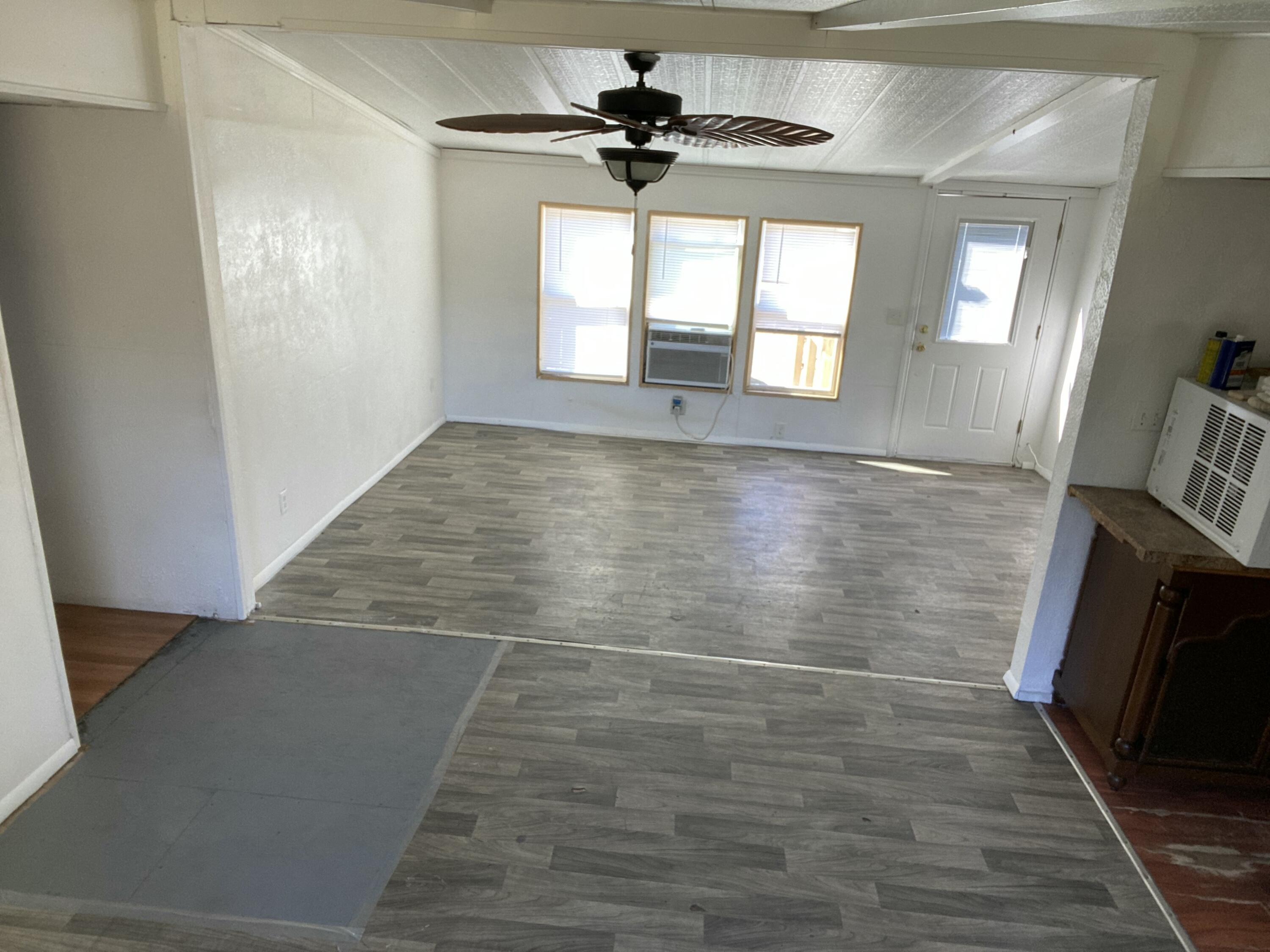 7835 Southeast 60th Drive Okeechobee, FL 34974 - Photo 4 of 35 a view of an empty room with window and wooden floor