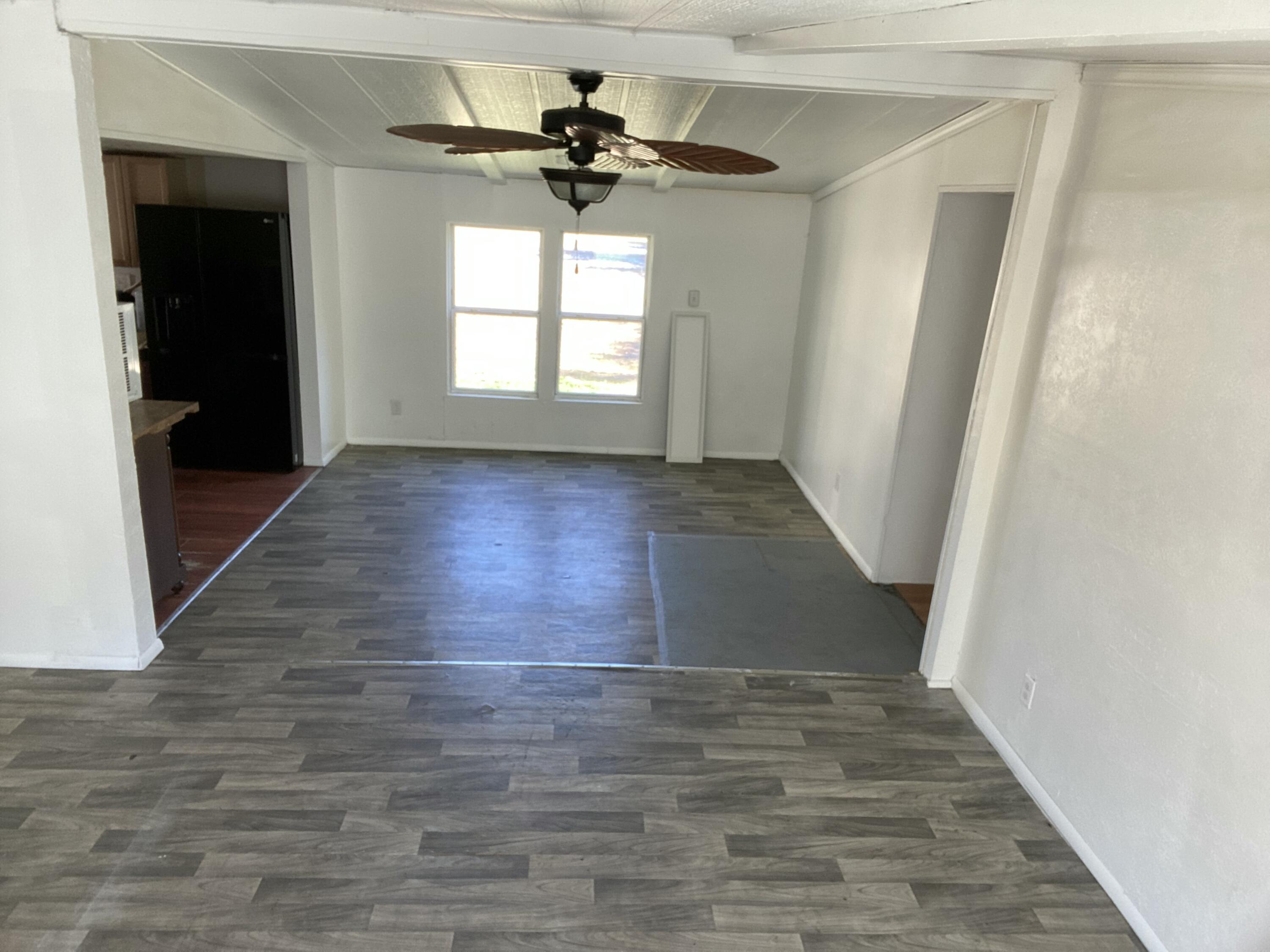7835 Southeast 60th Drive Okeechobee, FL 34974 - Photo 7 of 35 wooden floor in an empty room with a window