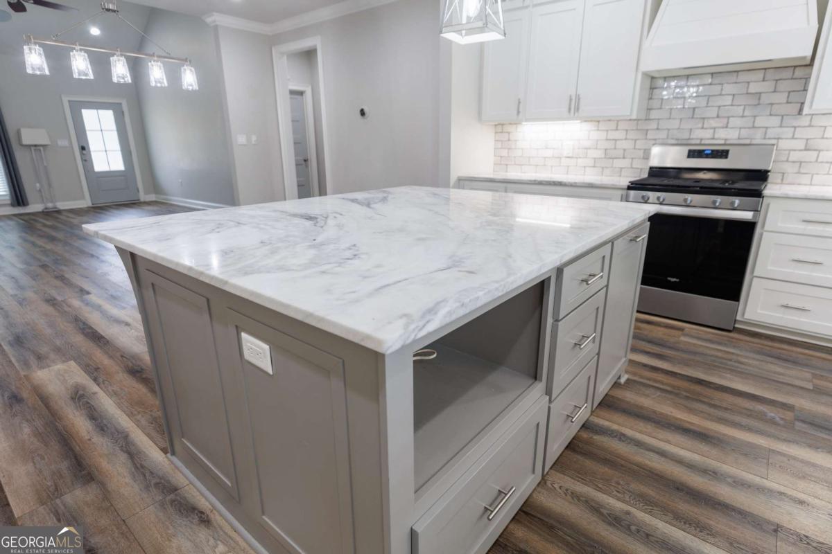 601 Pine Point Circle Valdosta, GA 31602 - Photo 14 of 45 a kitchen with stainless steel appliances granite countertop a kitchen island a stove and a sink