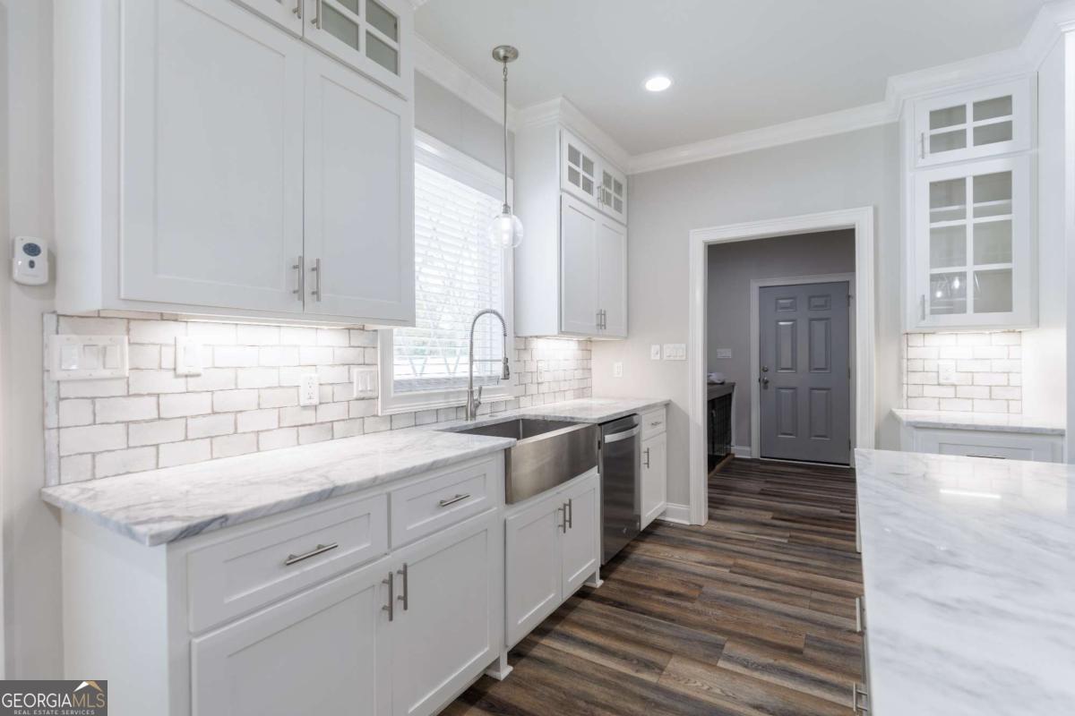 601 Pine Point Circle Valdosta, GA 31602 - Photo 16 of 45 a kitchen with granite countertop white cabinets and white appliances