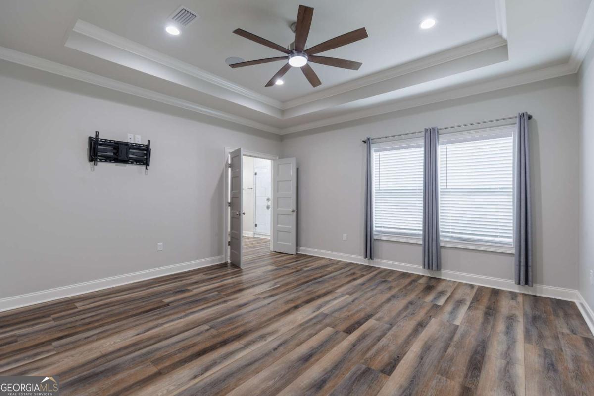 601 Pine Point Circle Valdosta, GA 31602 - Photo 19 of 45 wooden floor in an empty room with a window
