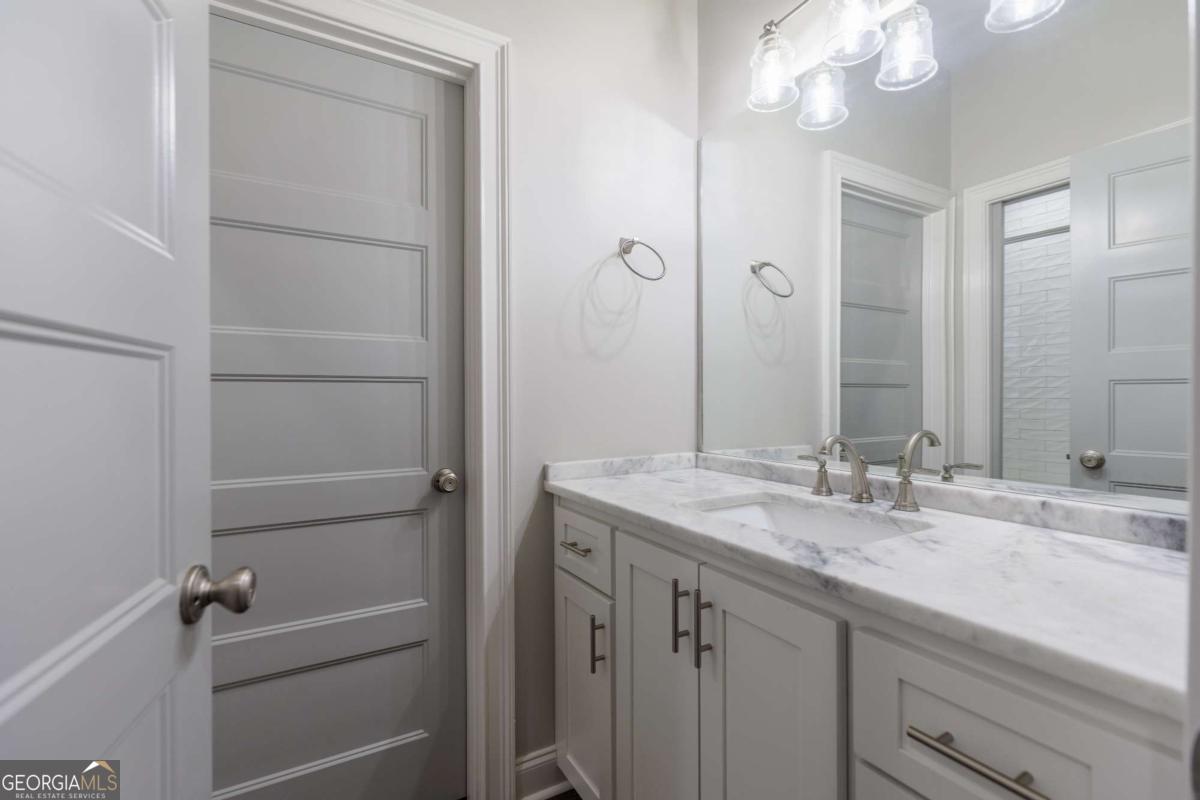 601 Pine Point Circle Valdosta, GA 31602 - Photo 30 of 45 a bathroom with a granite countertop sink and a mirror