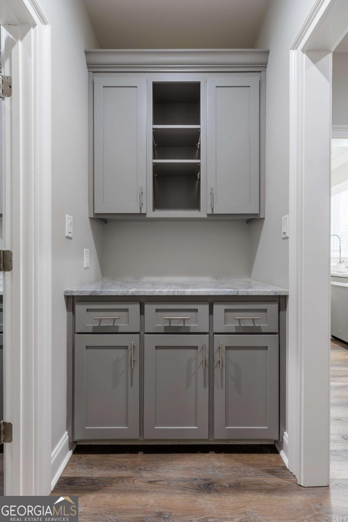 601 Pine Point Circle Valdosta, GA 31602 - Photo 36 of 45 a kitchen with granite countertop white cabinets and a stove