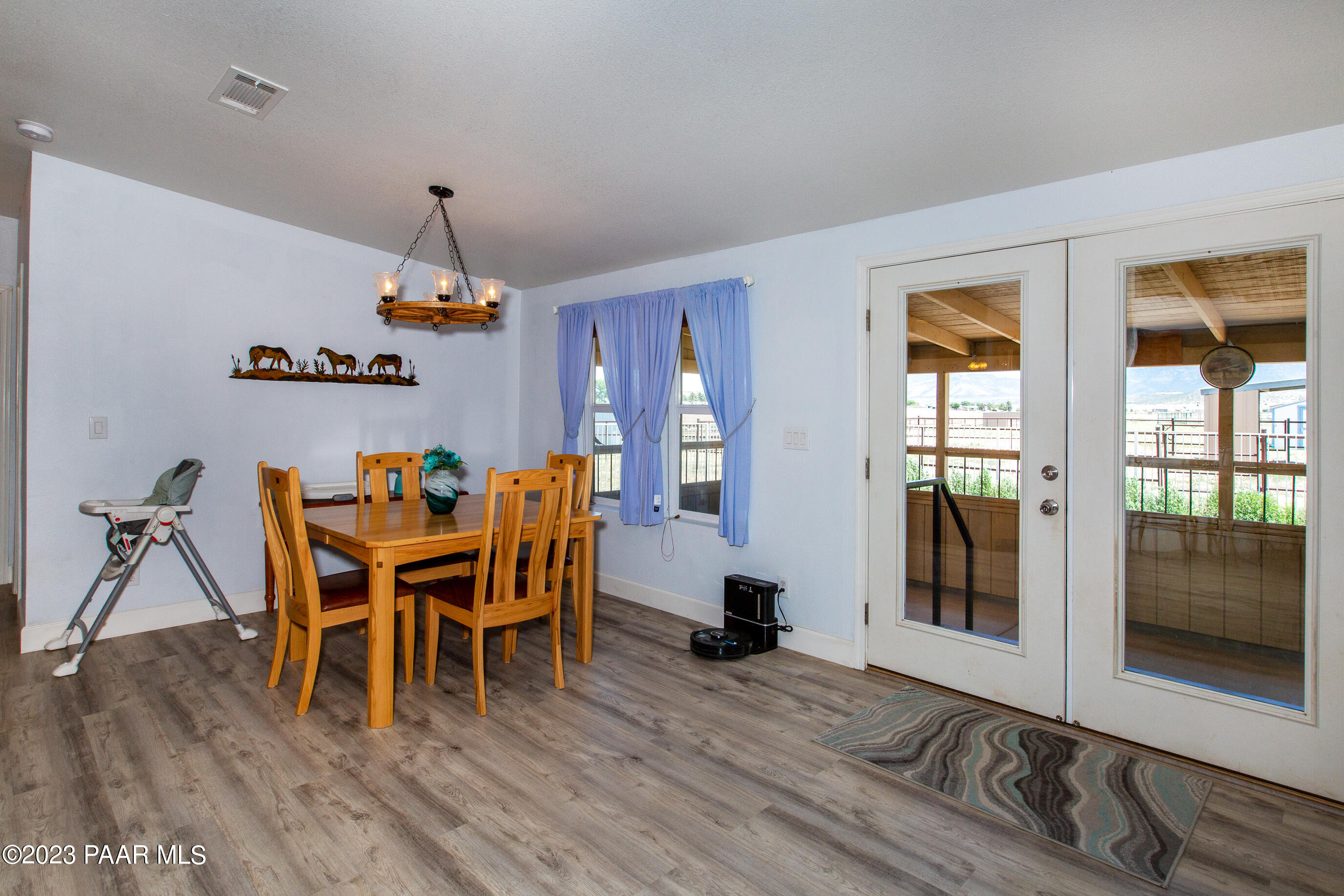 8855 East Turtle Rock Road Prescott Valley, AZ 86315 - Photo 11 of 62 a dining room with furniture and wooden floor