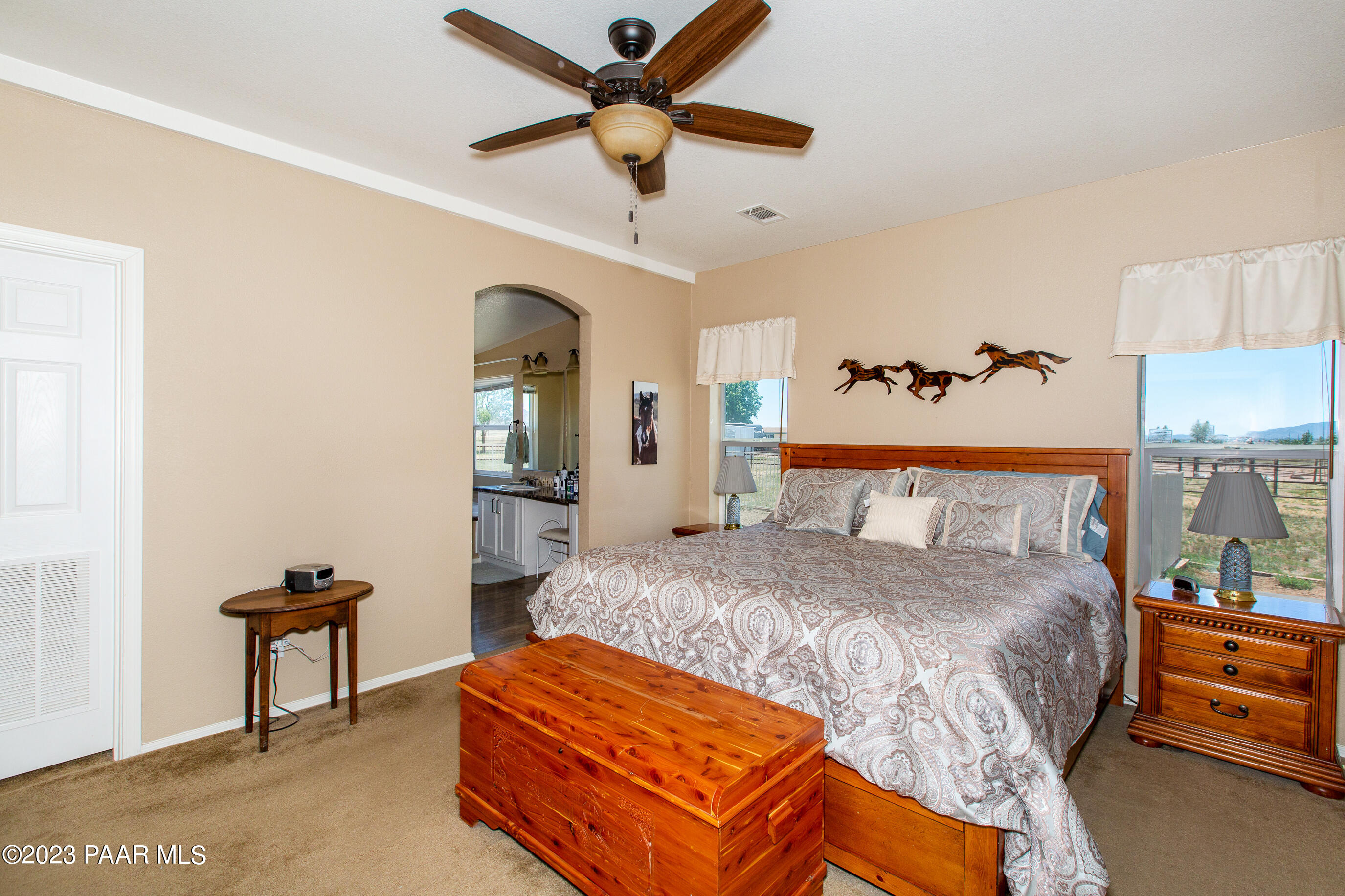 8855 East Turtle Rock Road Prescott Valley, AZ 86315 - Photo 16 of 62 a bedroom with a bed and a chandelier