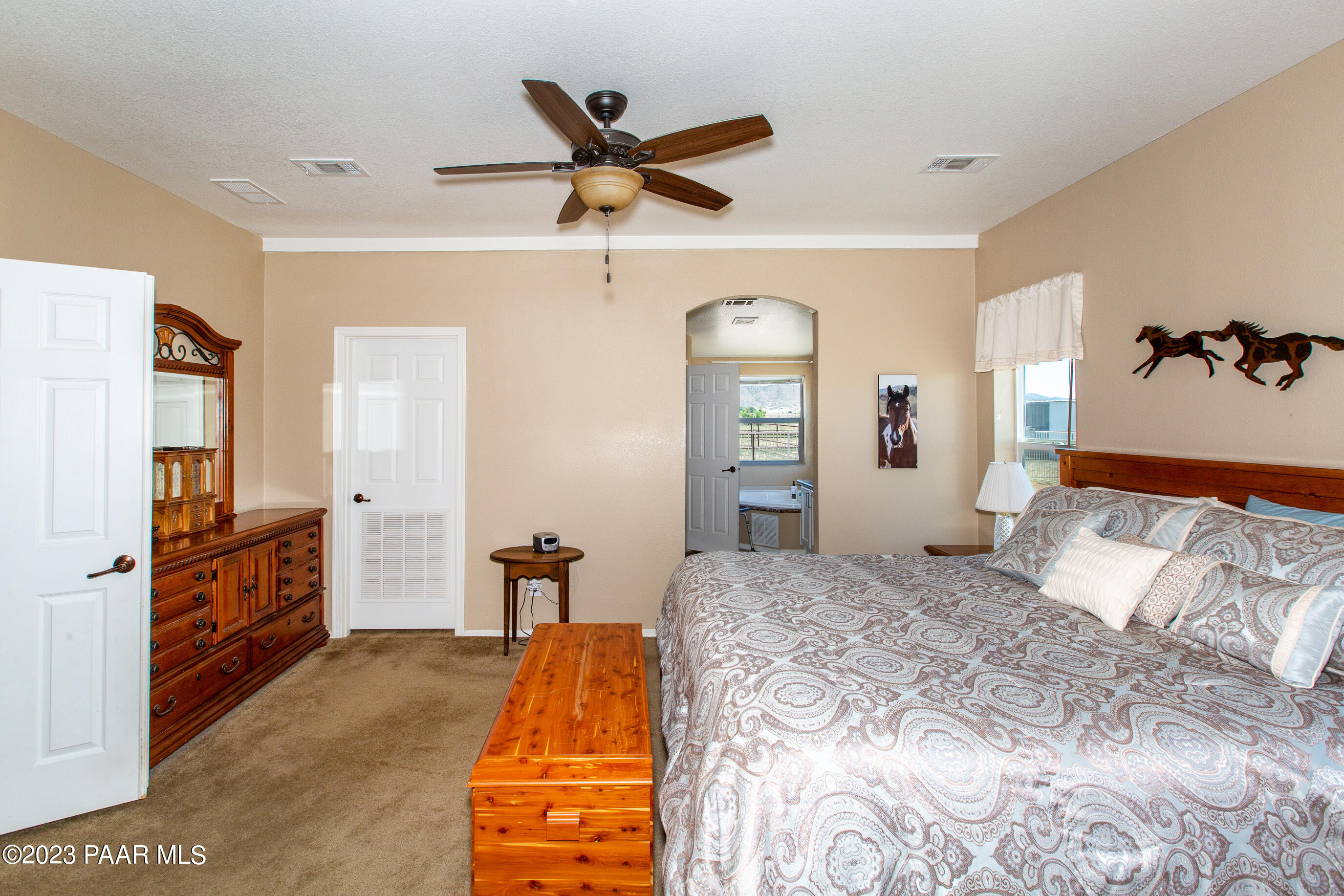 8855 East Turtle Rock Road Prescott Valley, AZ 86315 - Photo 17 of 62 a bedroom with a bed and dresser