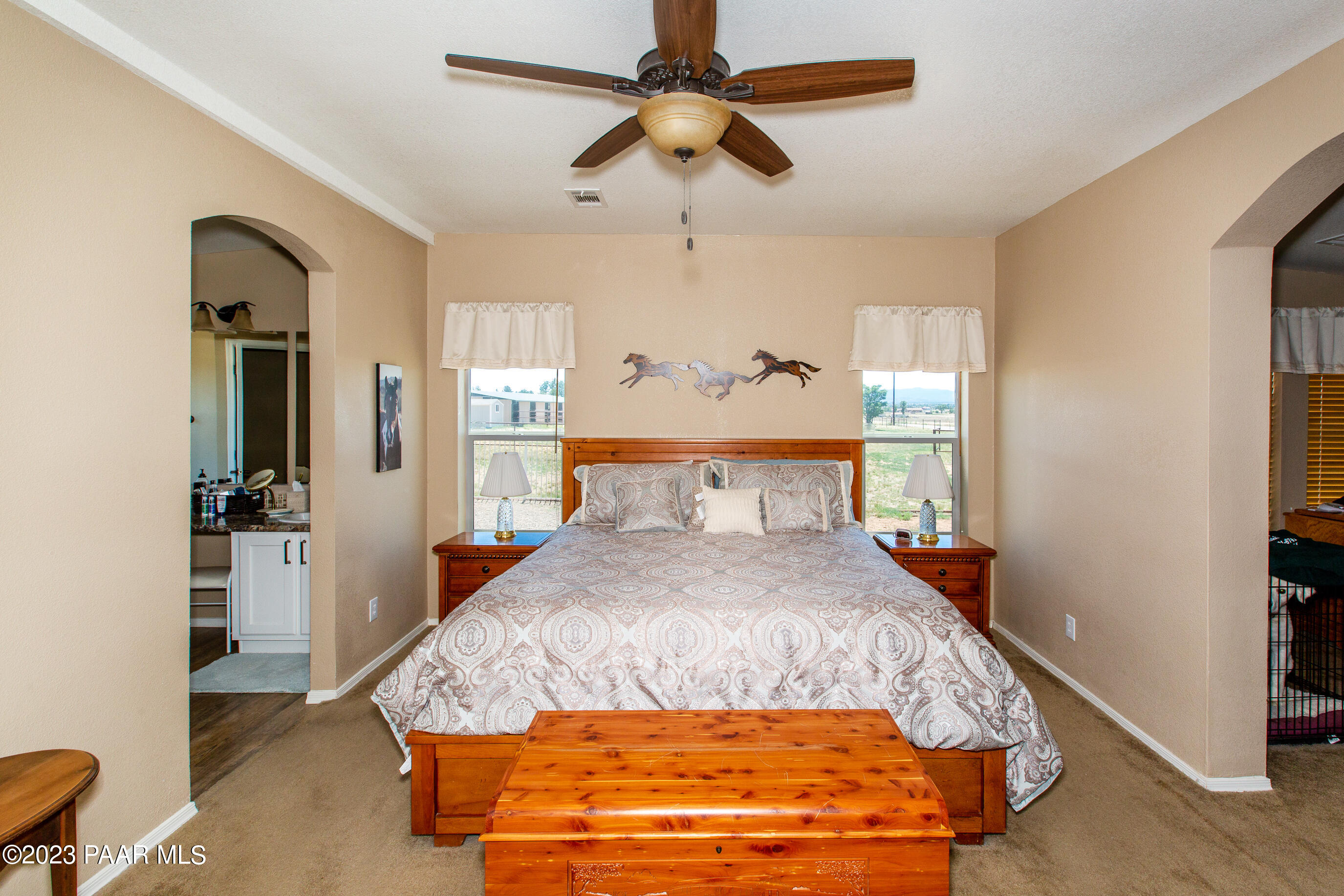 8855 East Turtle Rock Road Prescott Valley, AZ 86315 - Photo 18 of 62 a bed sitting in a bedroom next to a window