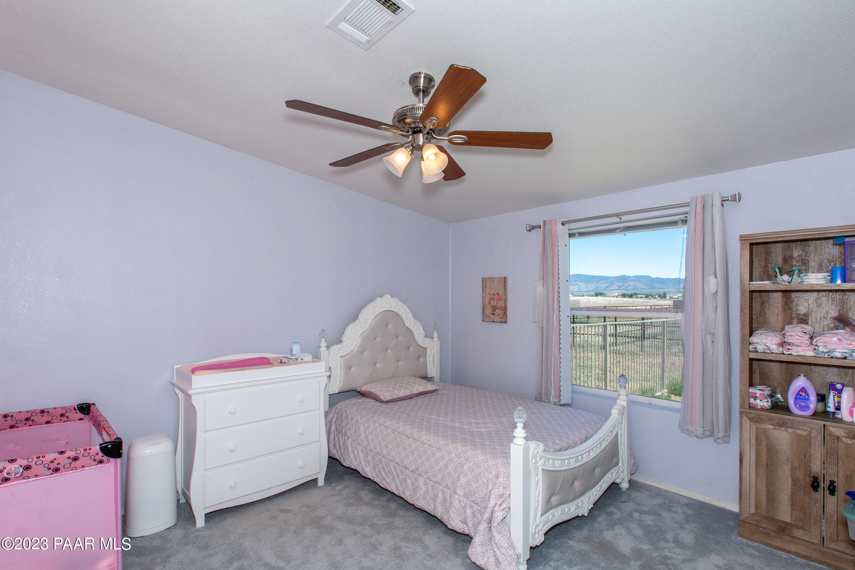 8855 East Turtle Rock Road Prescott Valley, AZ 86315 - Photo 22 of 62 a bedroom with a bed and a chandelier