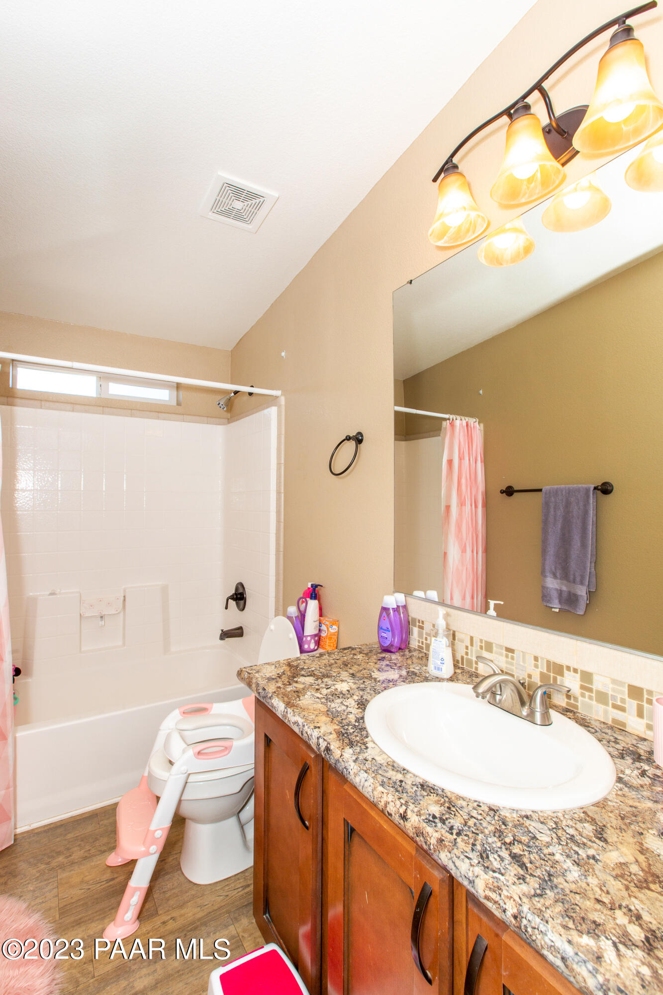 8855 East Turtle Rock Road Prescott Valley, AZ 86315 - Photo 24 of 62 a bathroom with a granite countertop sink mirror vanity and bathtub
