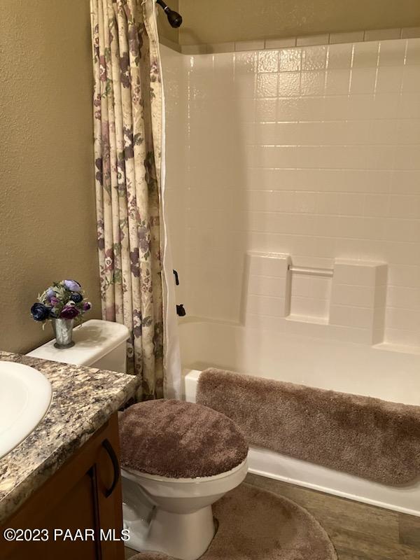 8855 East Turtle Rock Road Prescott Valley, AZ 86315 - Photo 29 of 62 a bathroom with a granite countertop sink a toilet and shower