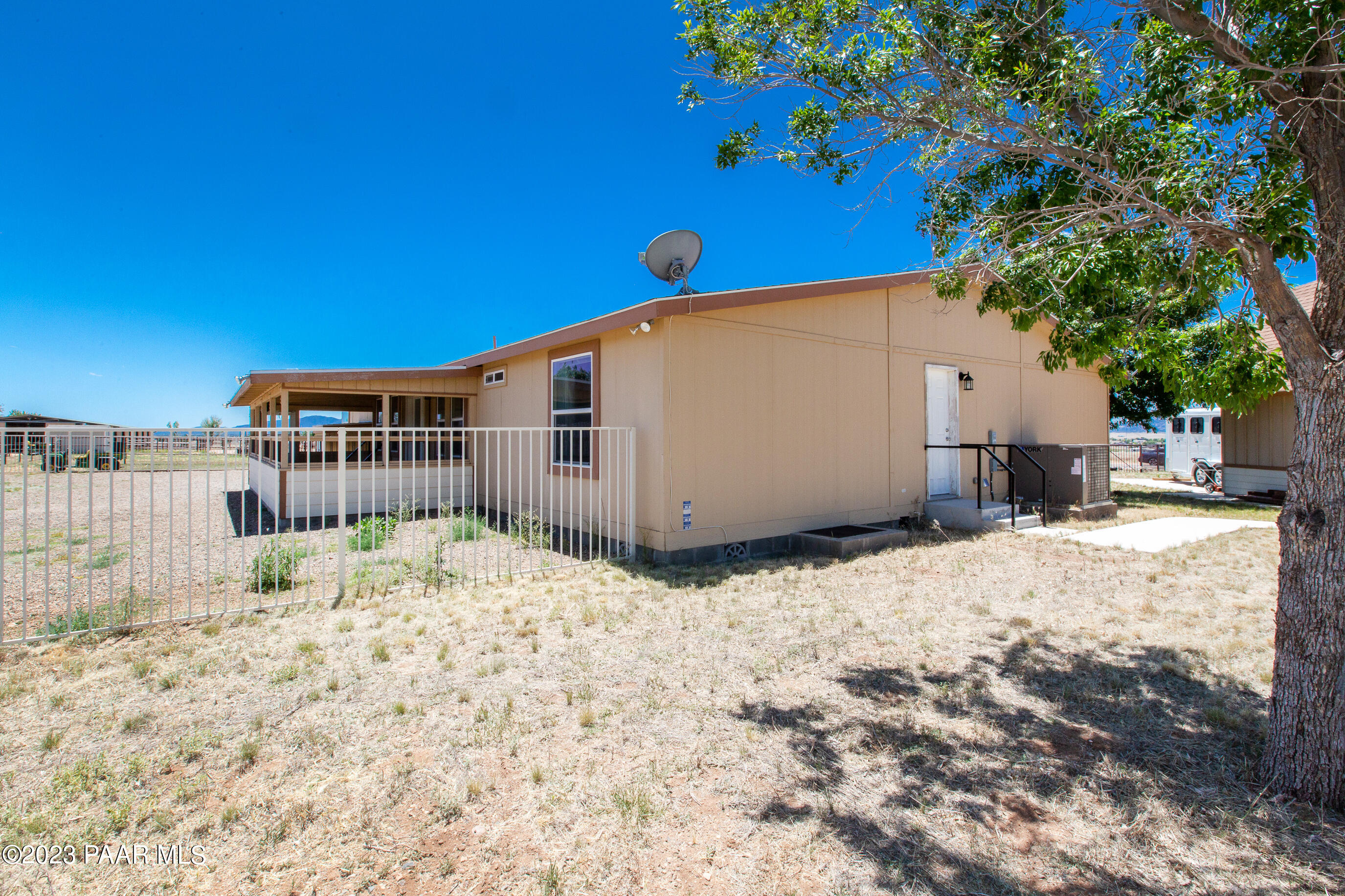 8855 East Turtle Rock Road Prescott Valley, AZ 86315 - Photo 56 of 62 a backyard of a house with a large tree