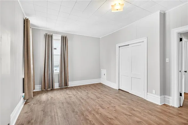 wooden floor in an empty room with a window
