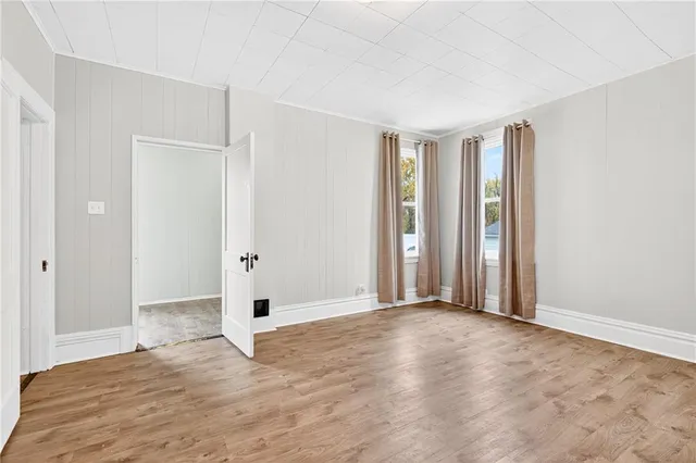 a view of empty room with wooden floor