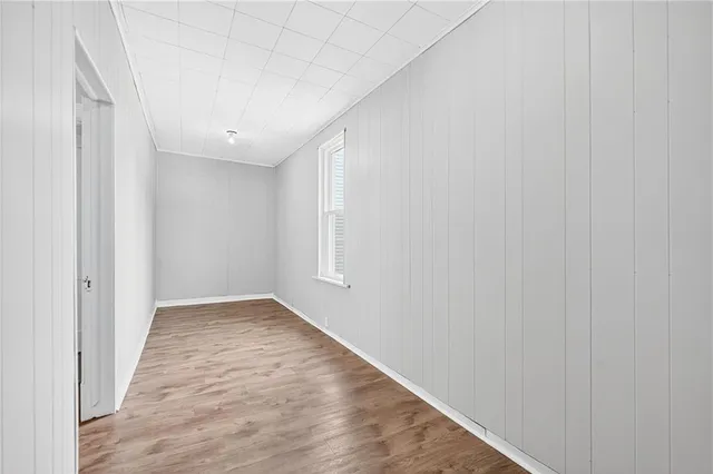 a view of hallway with wooden floor