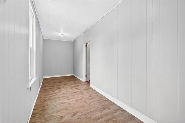 a view of hallway with wooden floor