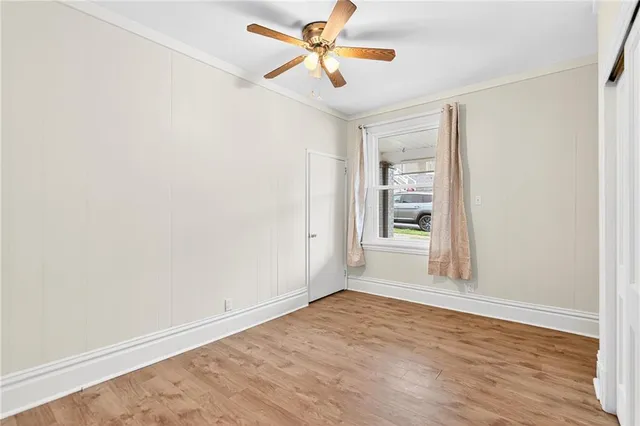 wooden floor in an empty room with a window