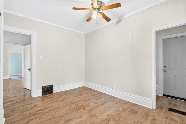 a view of empty room with wooden floor