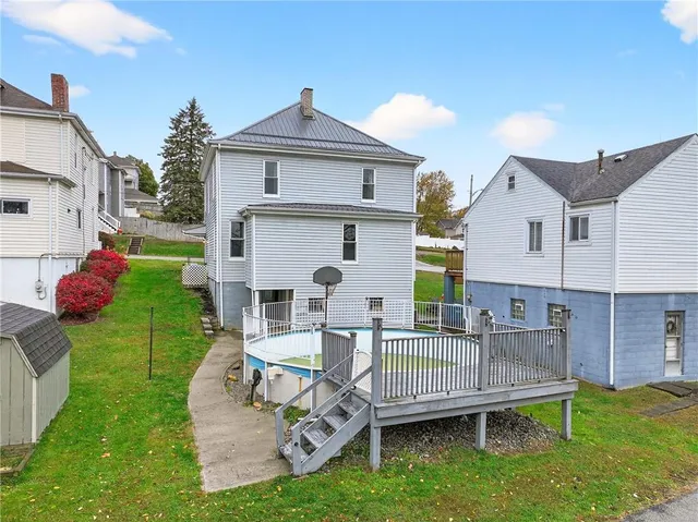 a view of a house with a yard and deck
