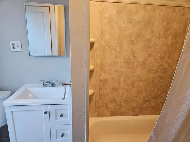 a white toilet sitting next to a bathroom sink