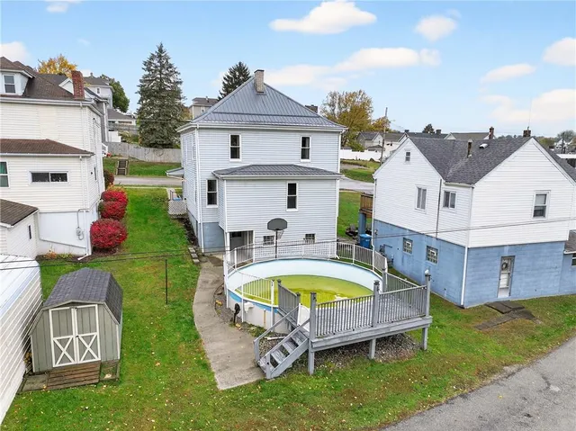 a swimming pool with outdoor seating and yard