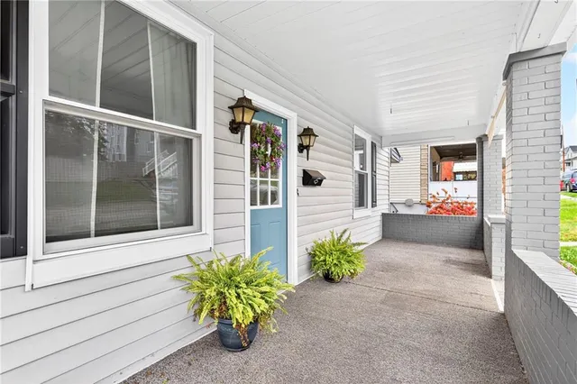 a front view of a house with a potted plant