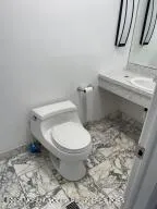a bathroom with a toilet and a sink