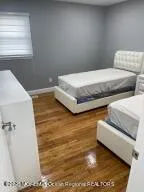 a bedroom with a bed and a window with rug