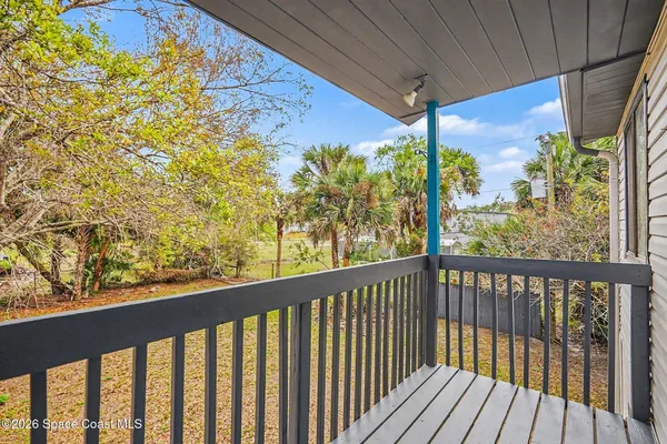 a view of a balcony with wooden floor