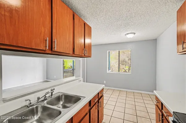 a kitchen with a sink cabinets and window