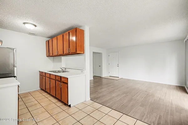 a kitchen with granite countertop a sink and a stove top oven