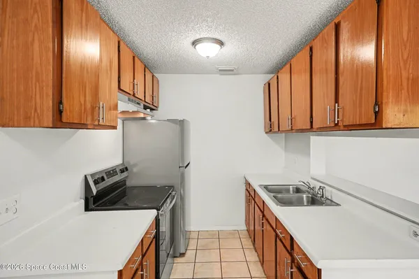 a kitchen that has a sink and a stove