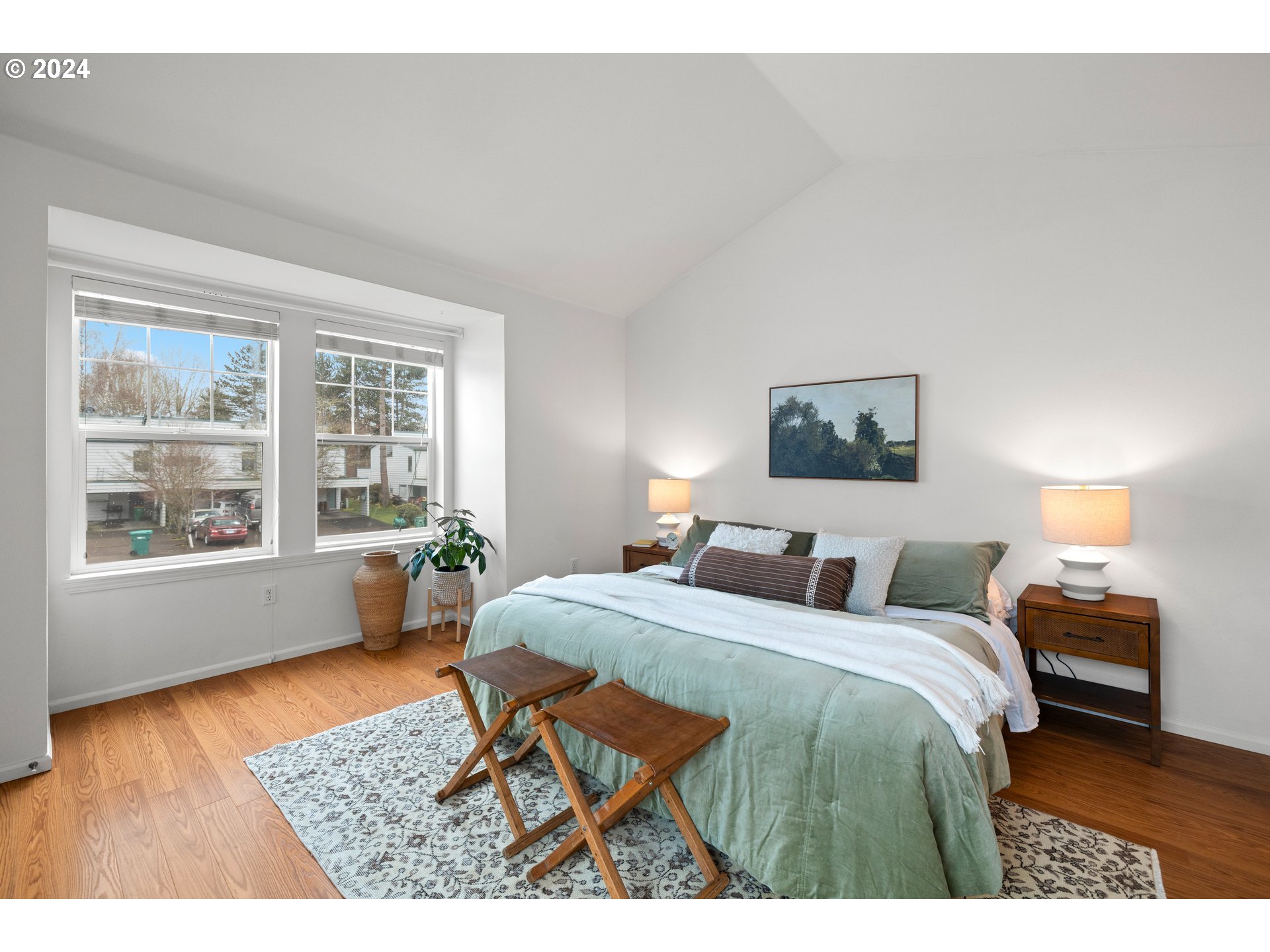 14525 Southwest 6th Street Beaverton, OR 97007 - Photo 8 of 14 a bedroom with a bed a table and a dresser next to a window