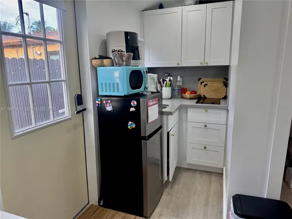 a kitchen with a refrigerator and cabinets