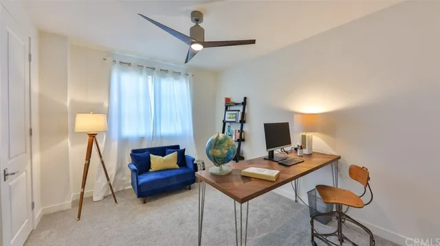 a bedroom with a bed and a lamp on dresser