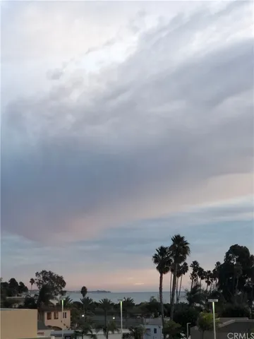 a view of a room that has a bed and wooden floor