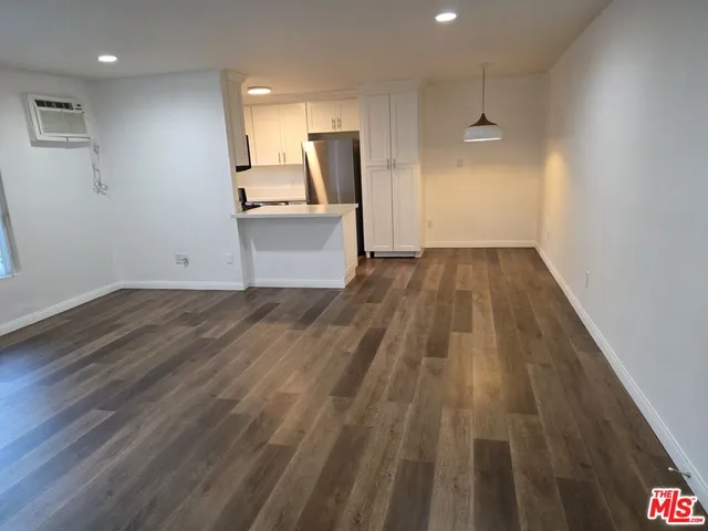 a view of a kitchen with wooden floor and a sink
