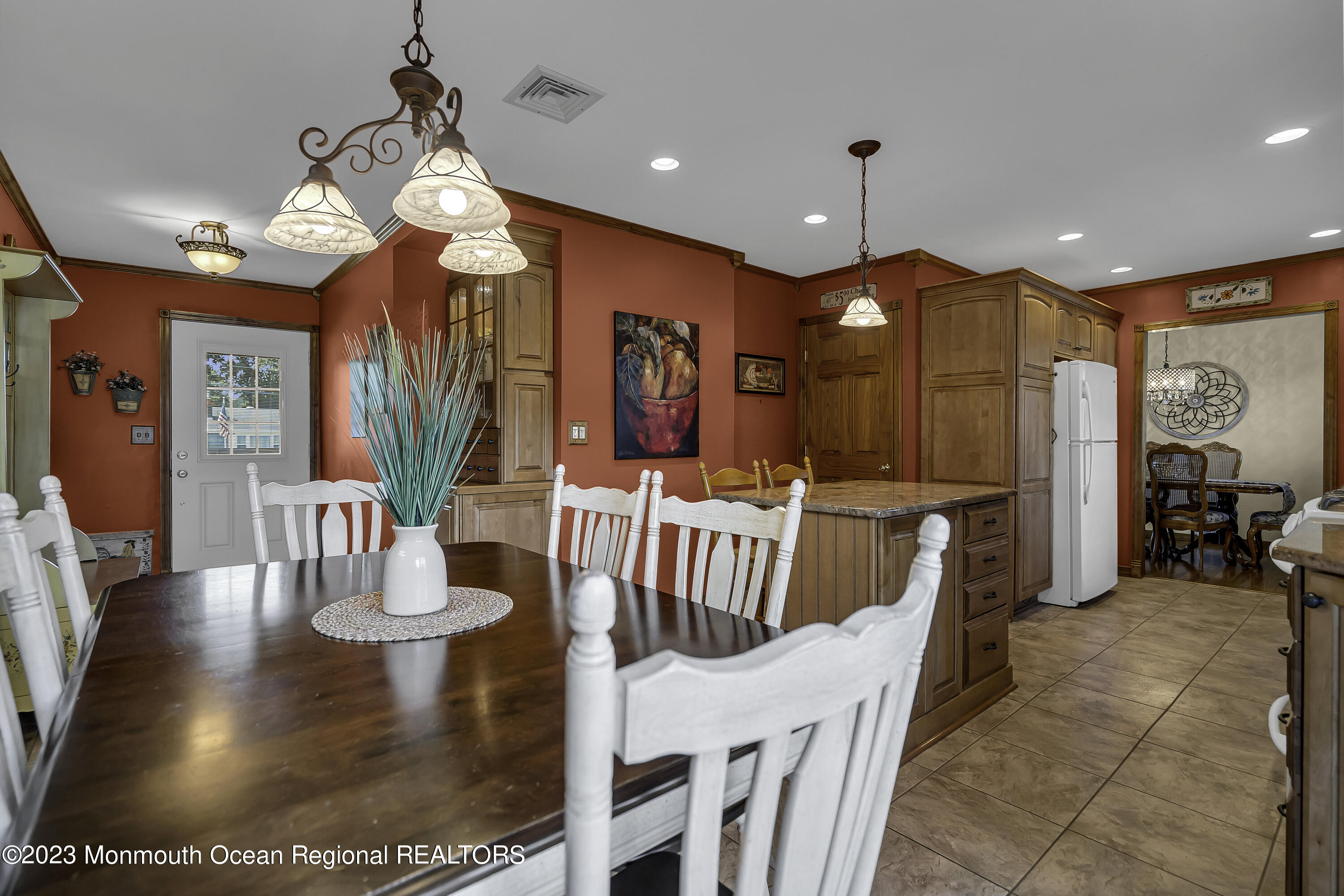 9 Delmore Road Freehold, NJ 07728 - Photo 17 of 44 a view of a dining room with furniture a chandelier and wooden floor