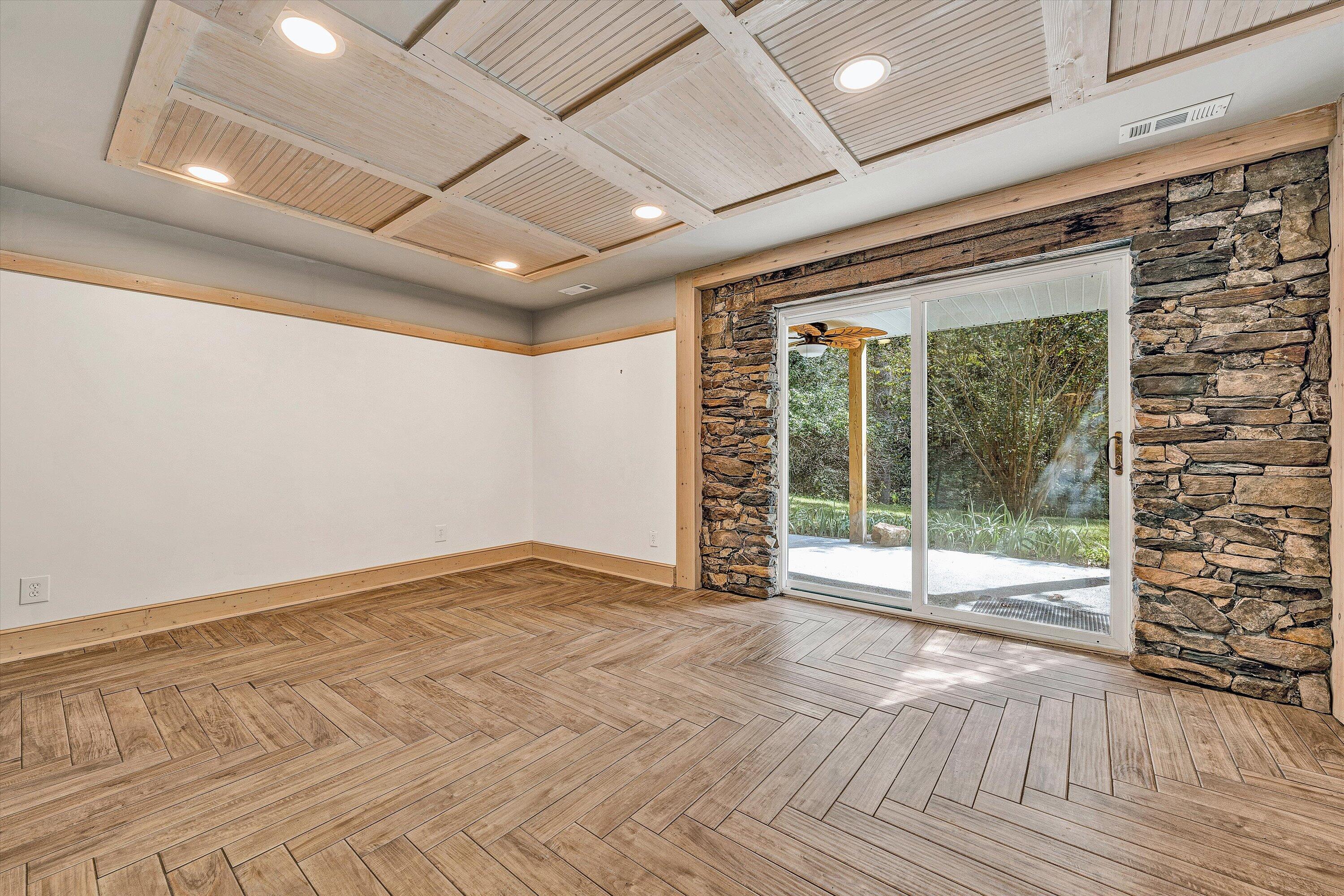 3561 Rutrough Road Southeast Roanoke, VA 24014 - Photo 16 of 63 a view of an empty room with wooden floor and a sliding door