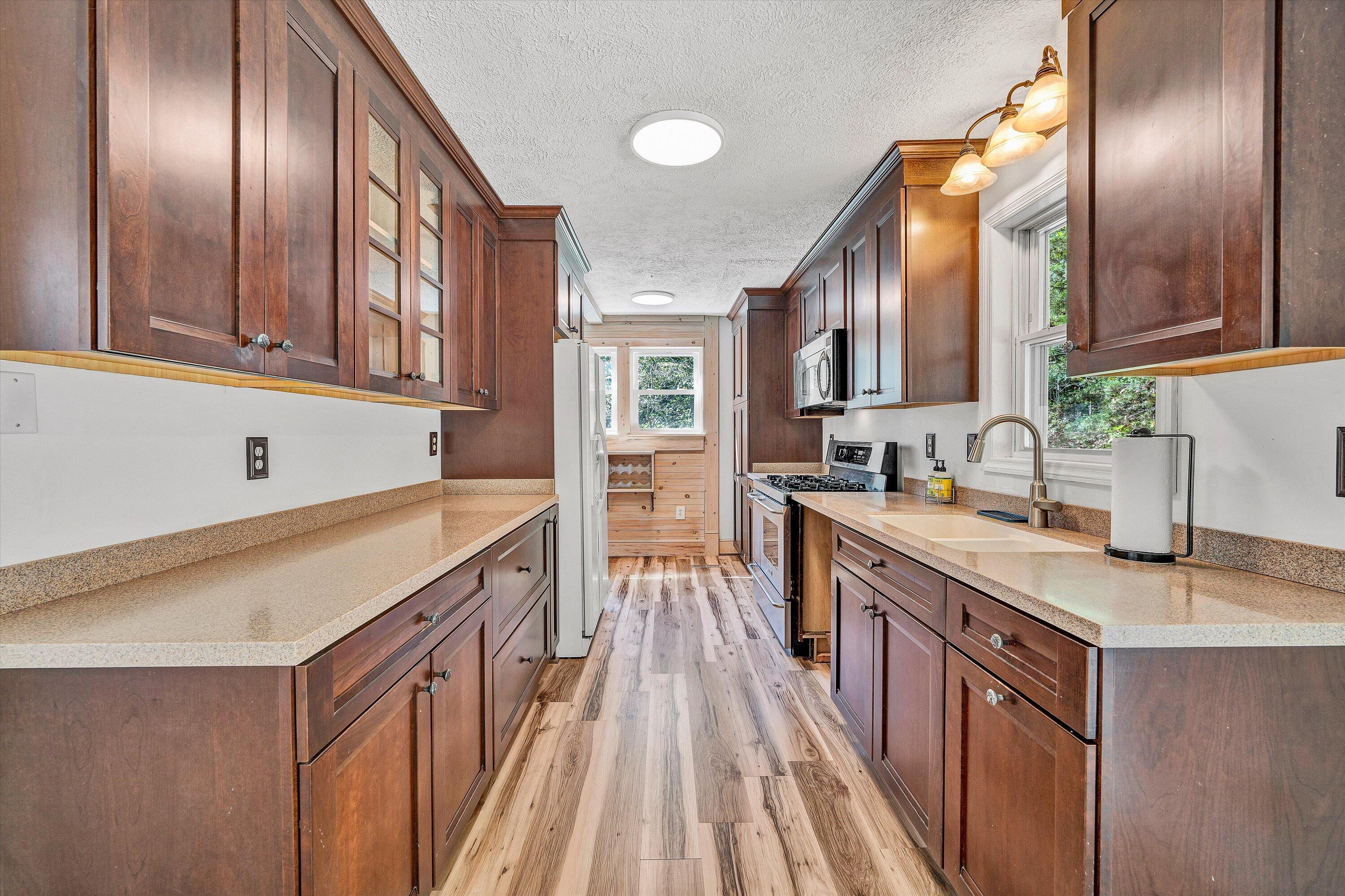 3561 Rutrough Road Southeast Roanoke, VA 24014 - Photo 27 of 63 a kitchen with stainless steel appliances granite countertop a sink and dishwasher a oven with wooden cabinets