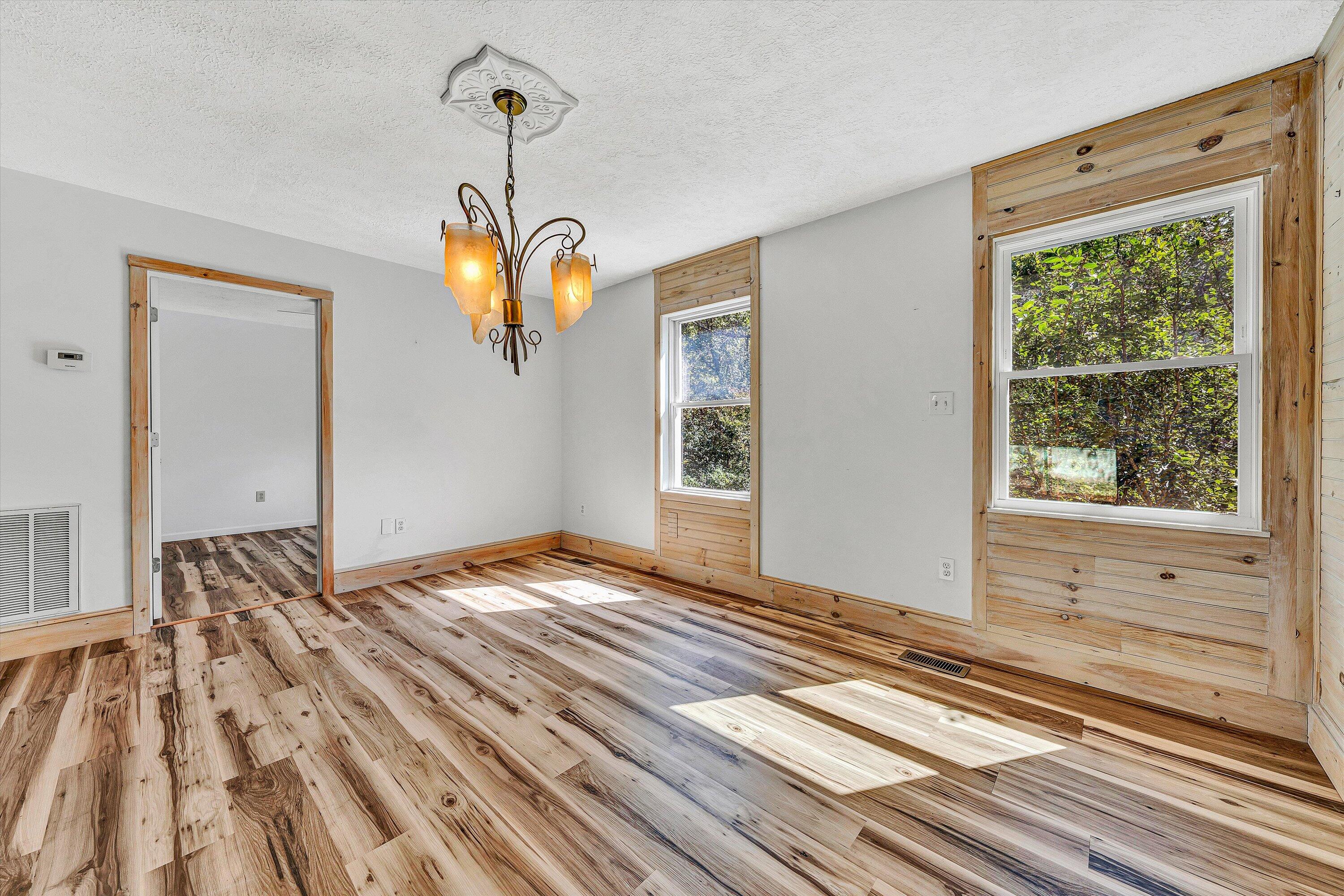 3561 Rutrough Road Southeast Roanoke, VA 24014 - Photo 35 of 63 a bedroom with a bed and wooden floor