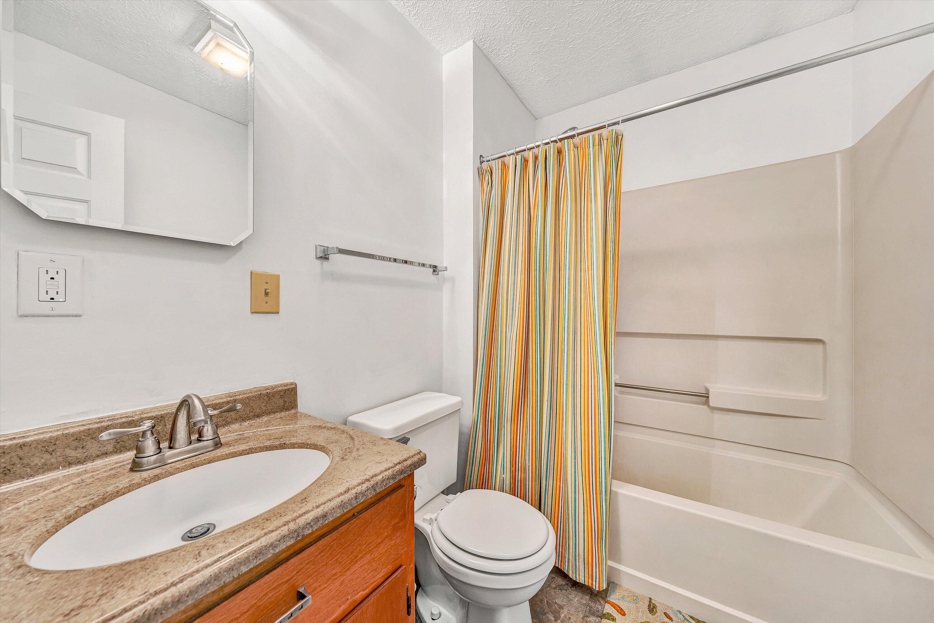 3561 Rutrough Road Southeast Roanoke, VA 24014 - Photo 40 of 63 a bathroom with a granite countertop sink toilet and shower