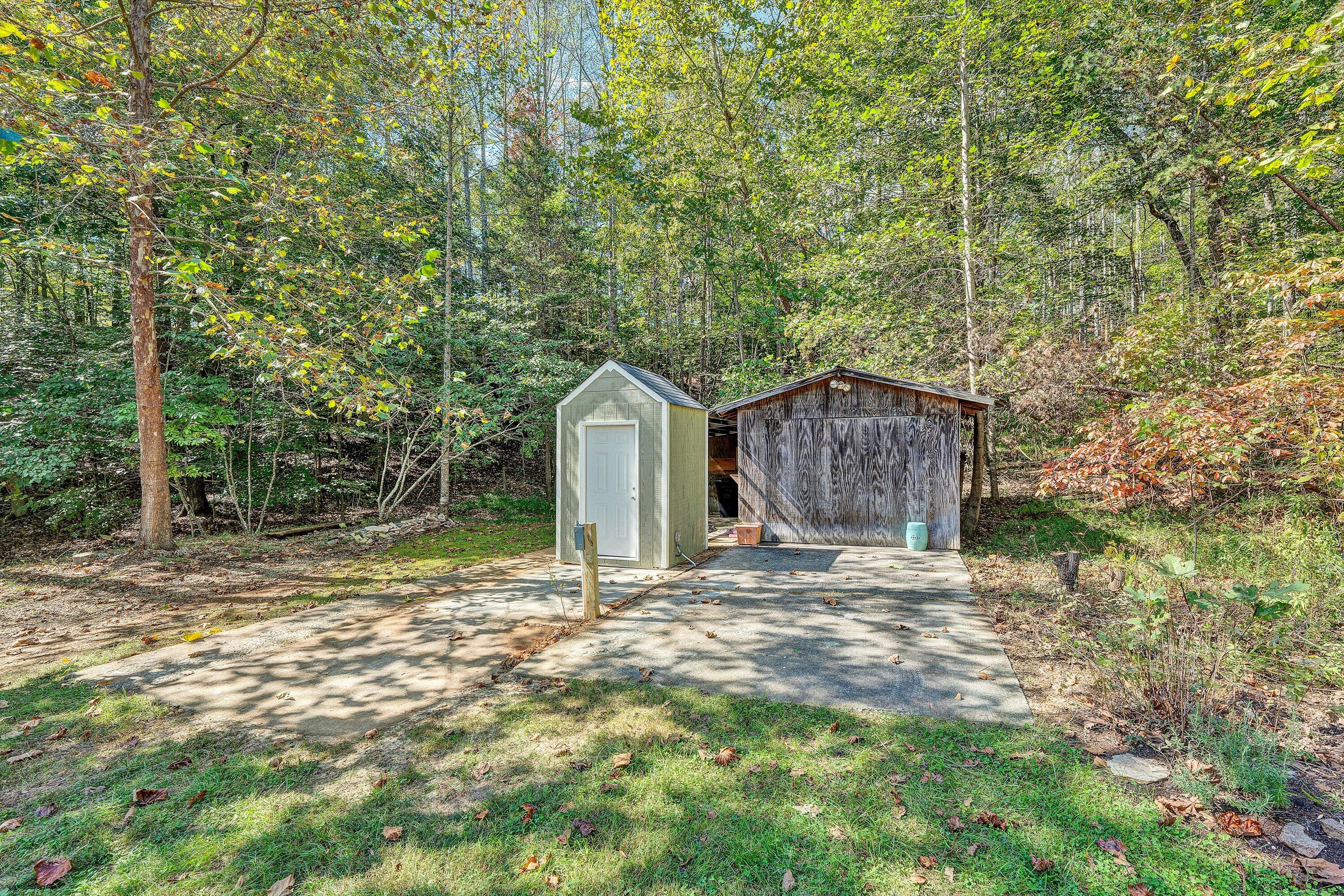 3561 Rutrough Road Southeast Roanoke, VA 24014 - Photo 49 of 63 a backyard of a house with large trees and wooden fence